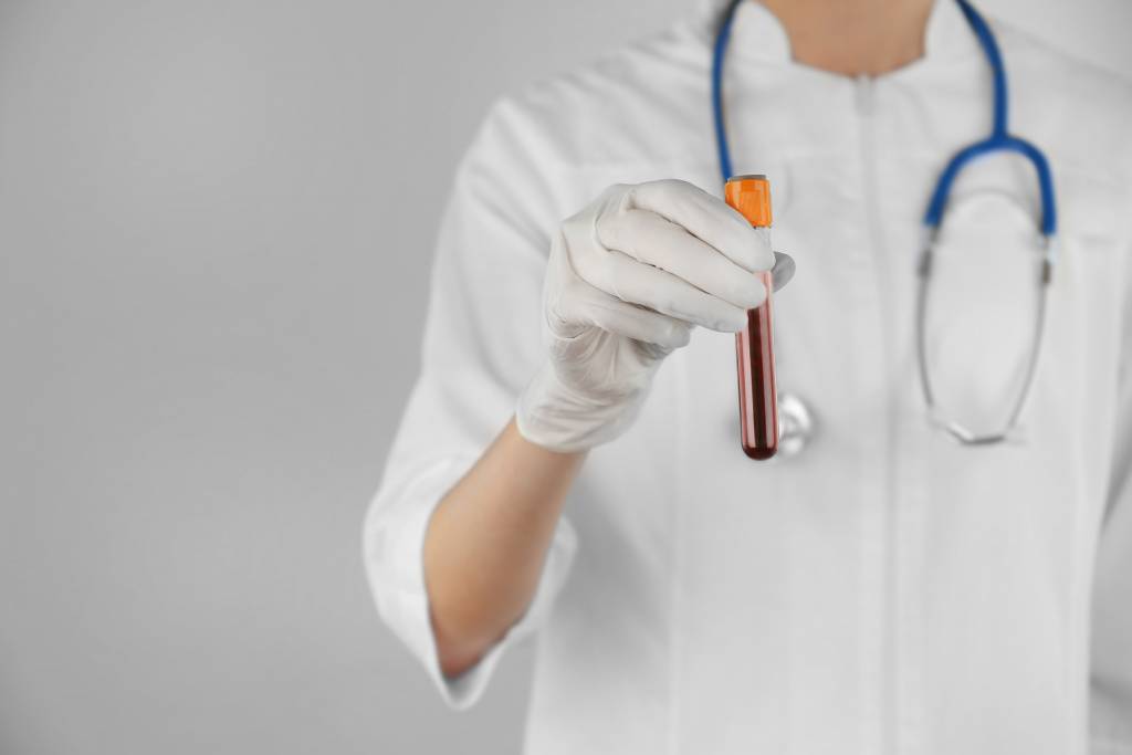 doctor-hand-glove-holding-test-tube-with-blood-light-background.jpg