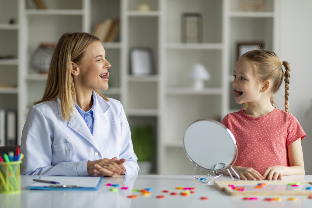 child-specialist-making-tongue-exercises-speech-therapy-session-with-little-girl.jpg